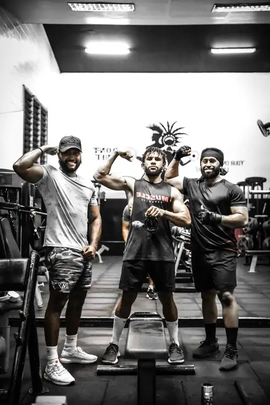 Client mid-set with arms flexed during a training session